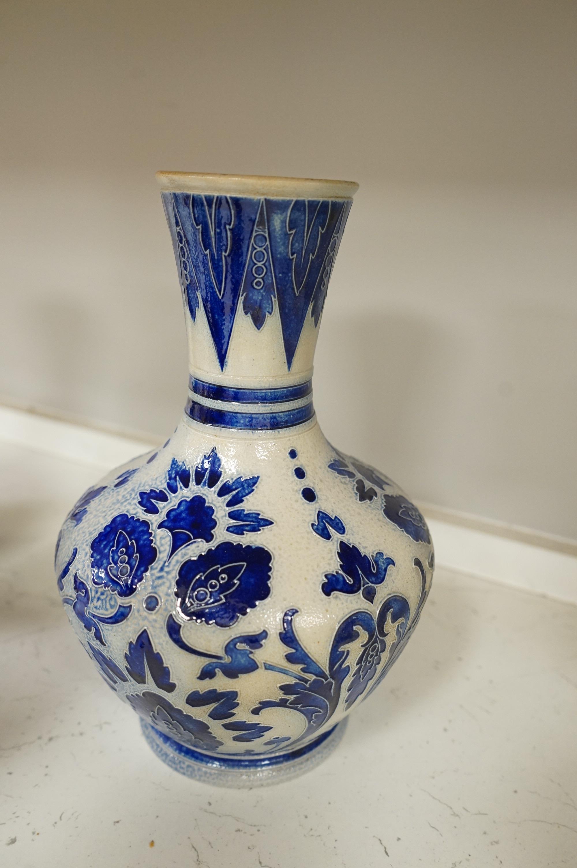 A collection of late 19th century and early 20th century European pottery and stoneware items to include a pair of glazed candlesticks stamped Belgium, largest 36cm high
